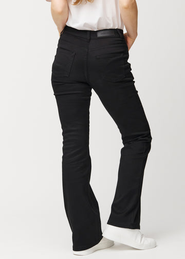 Black mid-rise bootcut jeans in Ravens. Back view on a model, showing the full fit.