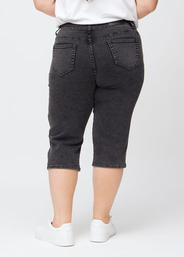 Dark grey denim regular capris seen from the back on a plus-size model, so the full product can be seen.