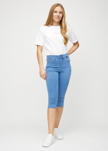 Full image of model in blue skinny capris.