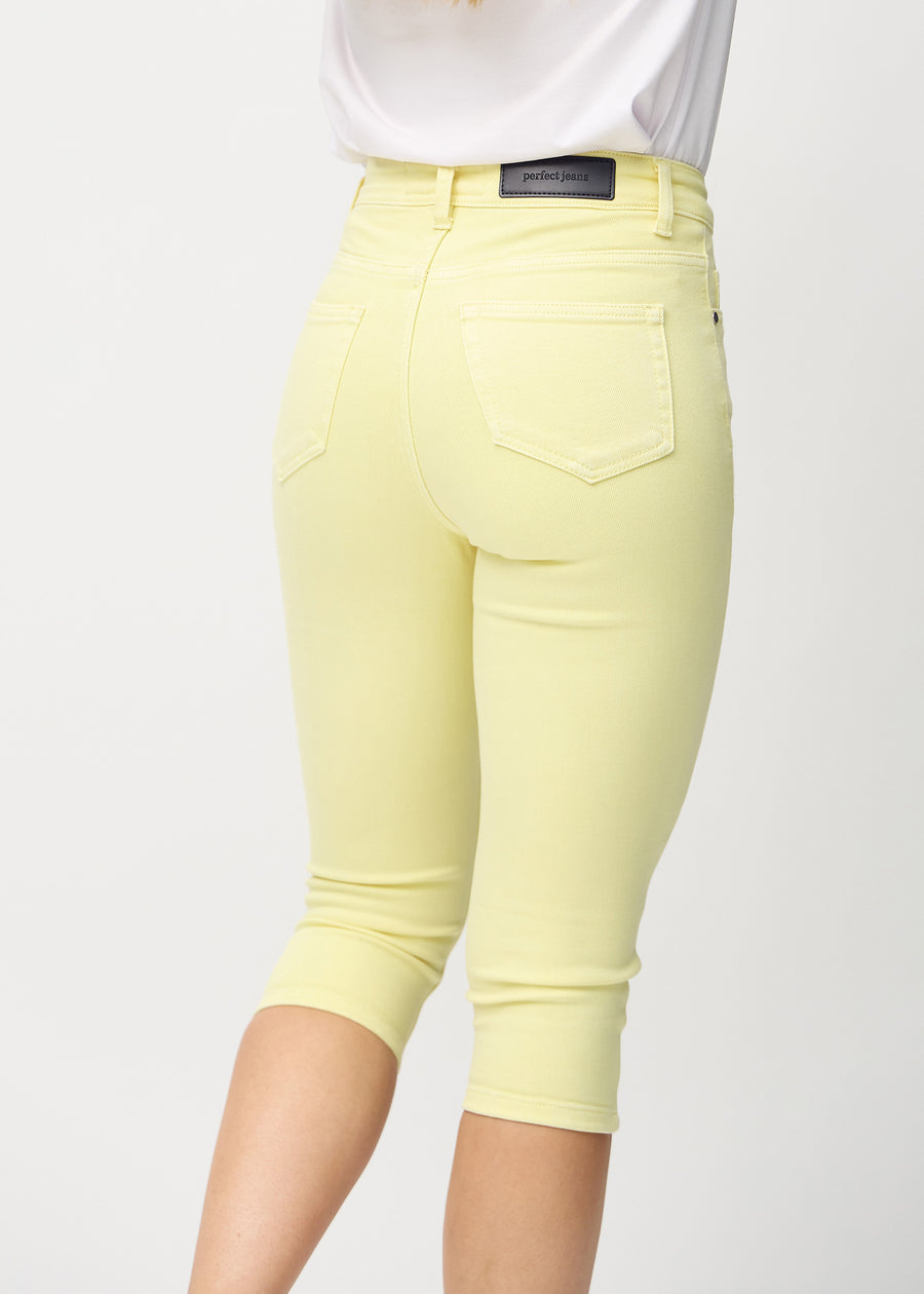 Image of woman in light yellow capris, back view.