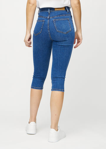 Dark denim skinny capris seen from the back, so the entire product can be seen.