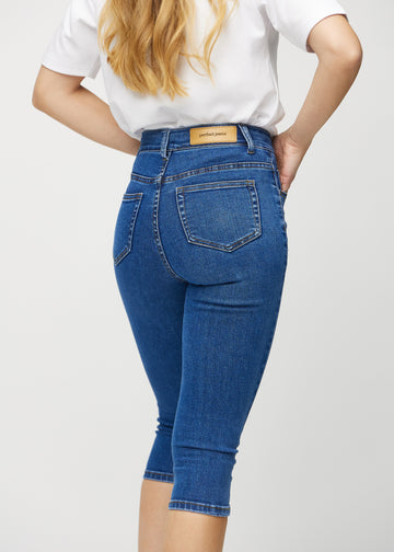 Dark denim skinny capris seen from the back close up to show details.