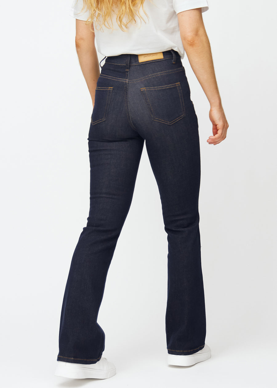 Deep dark blue denim jeans for women in the color Midnights seen from the back so the fit and flare can be seen.