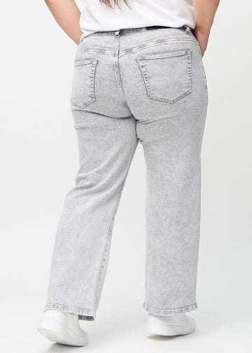 Light grey denim loose jeans seen from the back on a plus-size model, so the entire product can be seen.