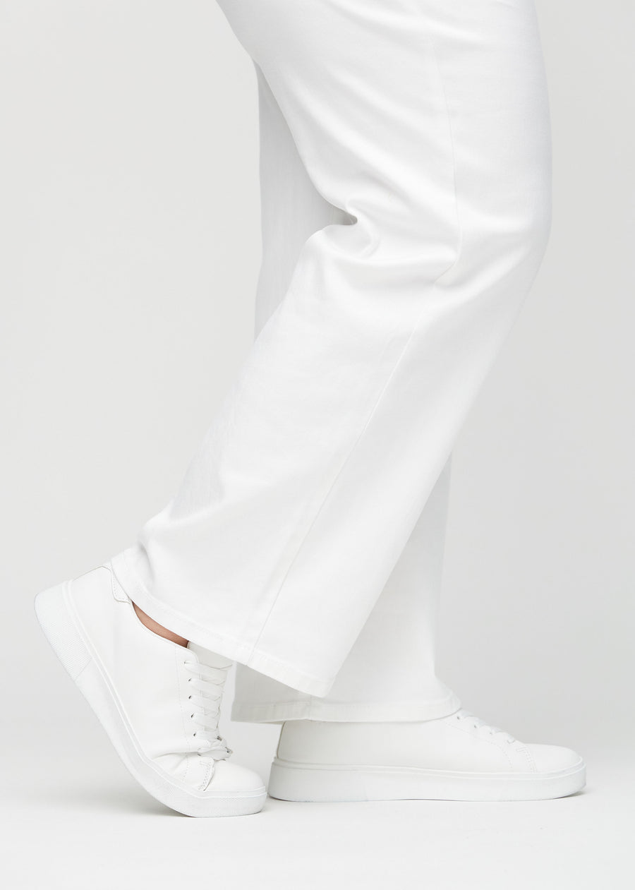 The ankles of a plus-size model, so you can see how loose the jeans fit.