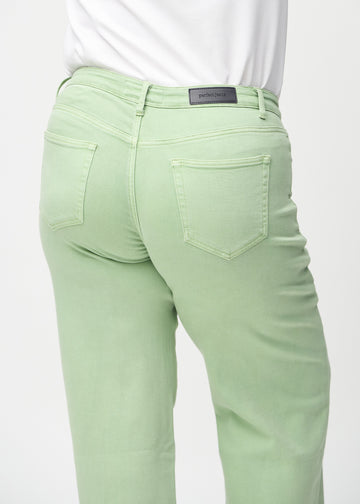 Loose jeans for women in light green, color Mints. Close-up from behind on a plus-size model, showing the fit and details.