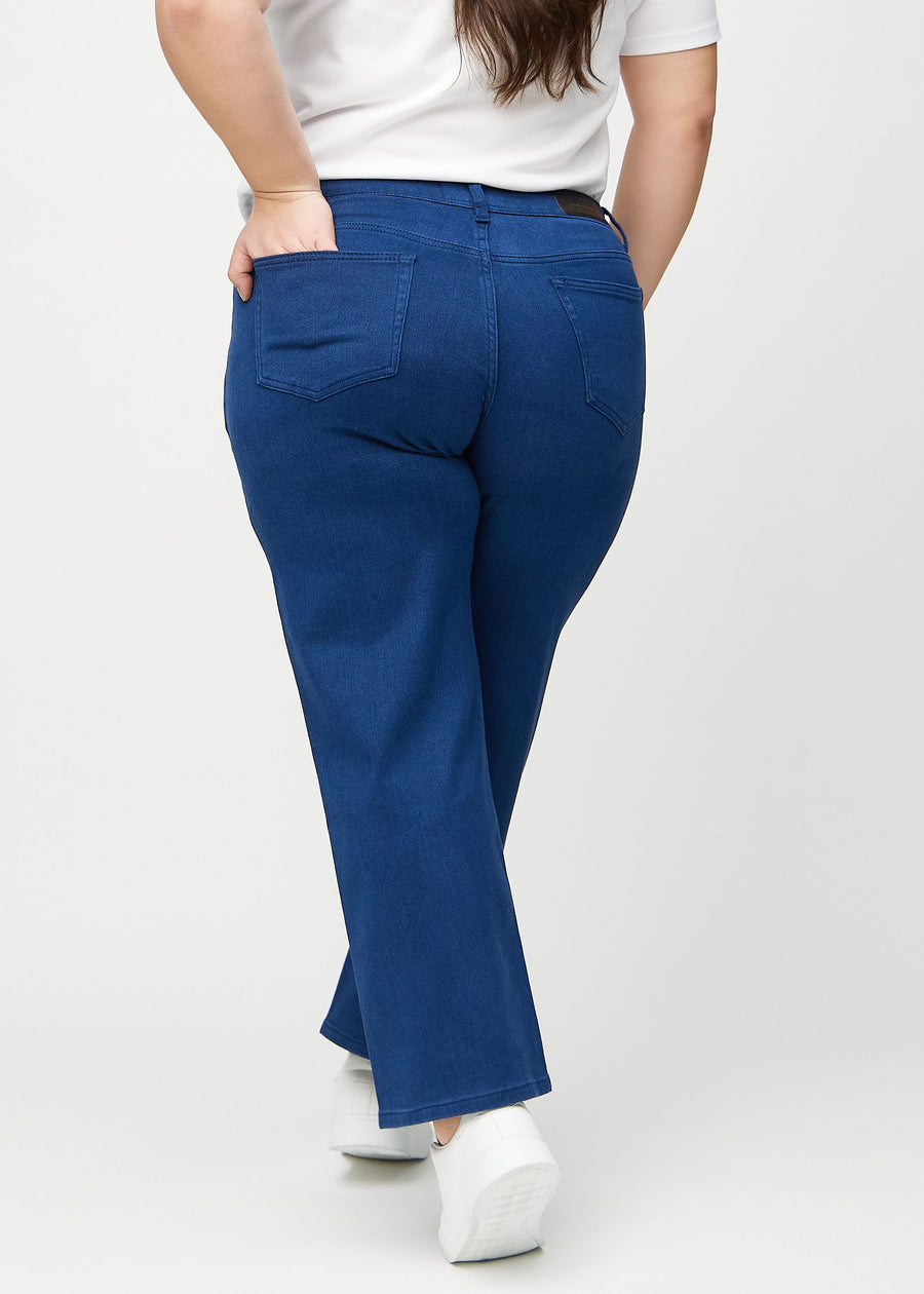 Dark blue loose jeans seen from the back on a plus-size model, so the entire product can be seen.