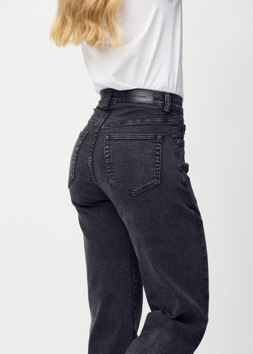 Loose jeans for women in dark grey, color Shadows. Close-up from behind on a model, showing the fit and details.