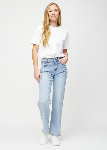 Full image of model in light denim loose jeans.