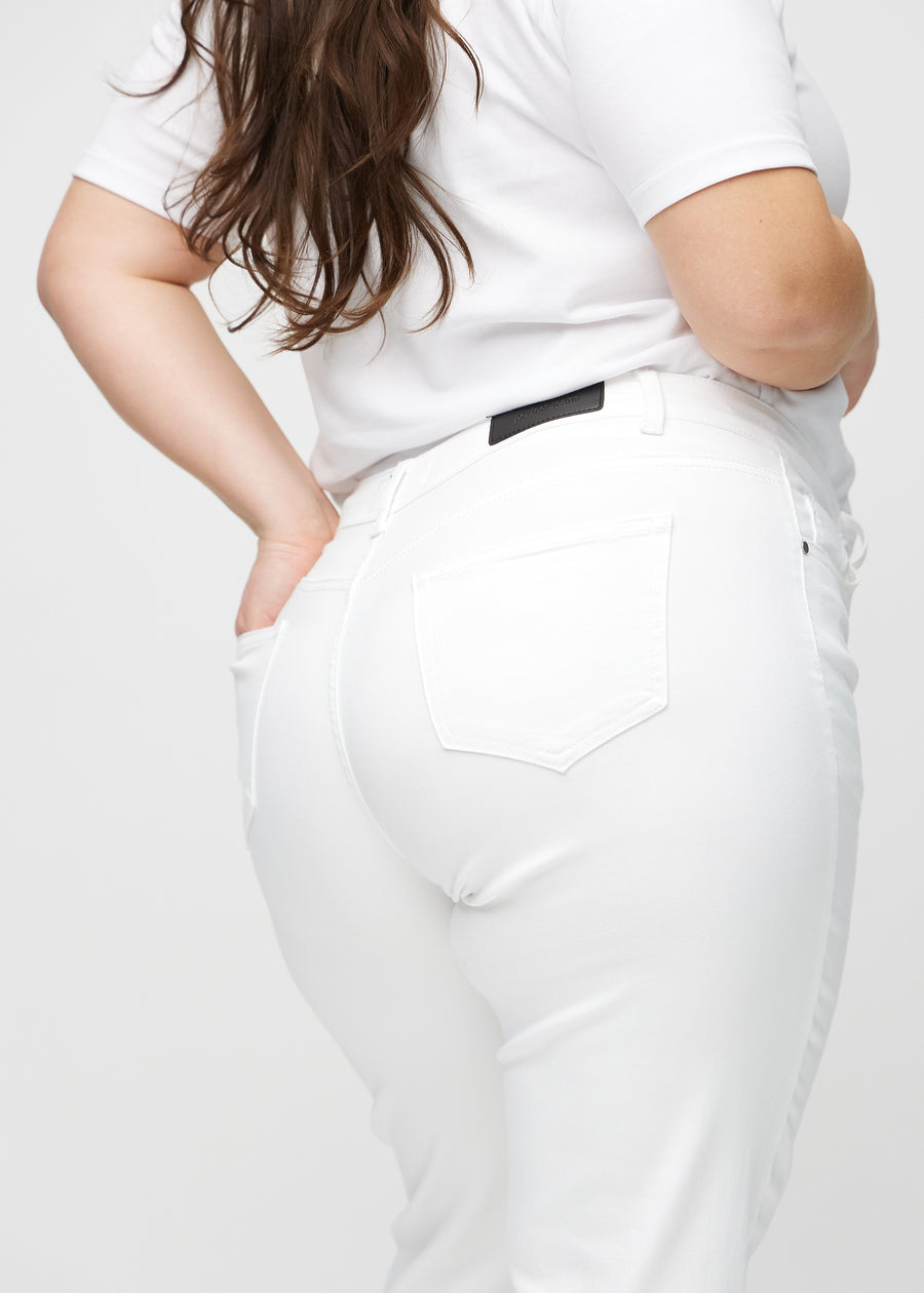 Regular jeans for women in white, color Marguerites. Close-up from behind on a plus-size model, showing fit and details.