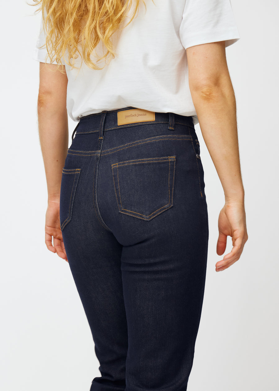 Deep dark blue denim jeans for women in the color Midnights, seen from the back close up to show fit and details.