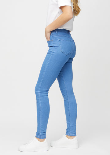 Skinny jeans for women in blue, color Geraniums. Side view on a model.