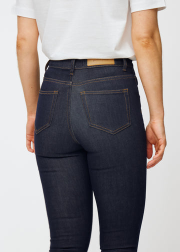 Deep dark blue denim jeans for women in the color Midnights viewed from the back in close-up to show fit and details.
