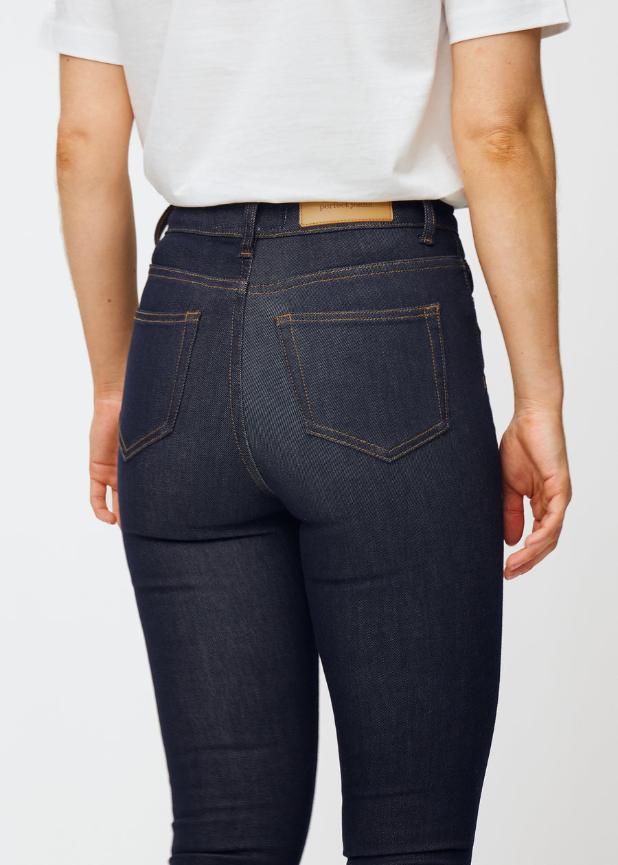 Deep dark blue denim jeans for women in the color Midnights viewed from the back in close-up to show fit and details.
