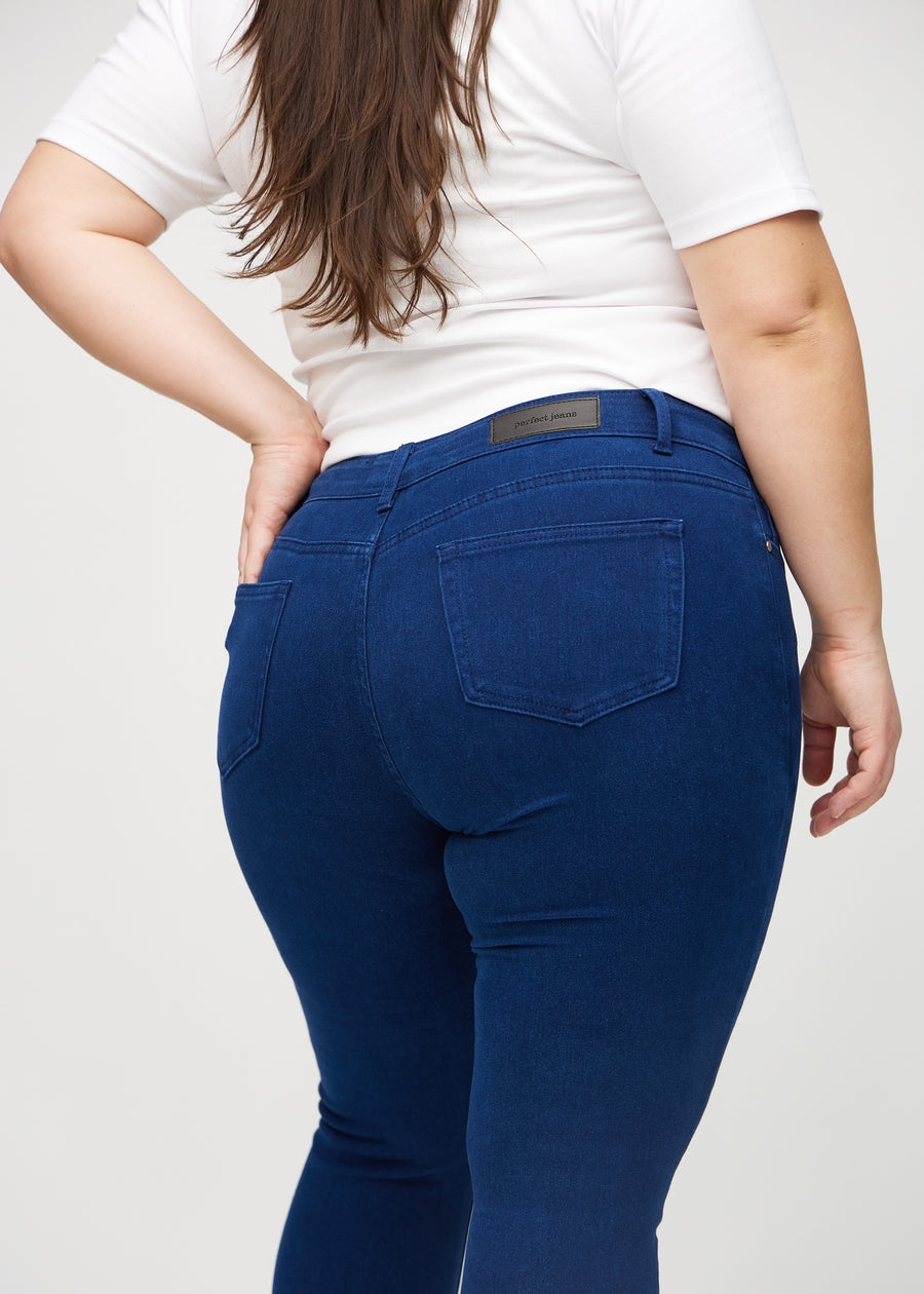Skinny jeans for women in dark blue, color Royals. Close-up back view on a plus-size model, showing the details.