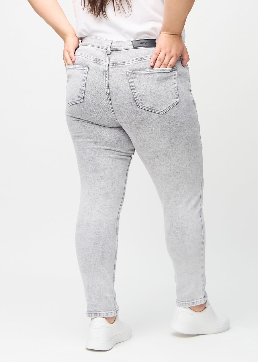 Light grey denim slim jeans seen from the back on a plus-size model, so the entire product can be seen.