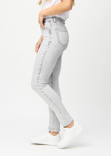 Light grey denim slim jeans seen from the side on a model.