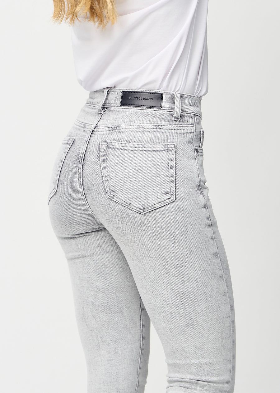 Light grey denim slim jeans seen from the back close up to show details.