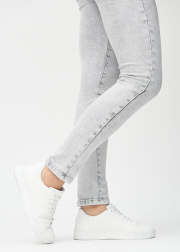 The ankles of a model, so you can see how tightly the jeans fit.