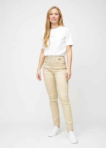 Full image of model in beige slim jeans.