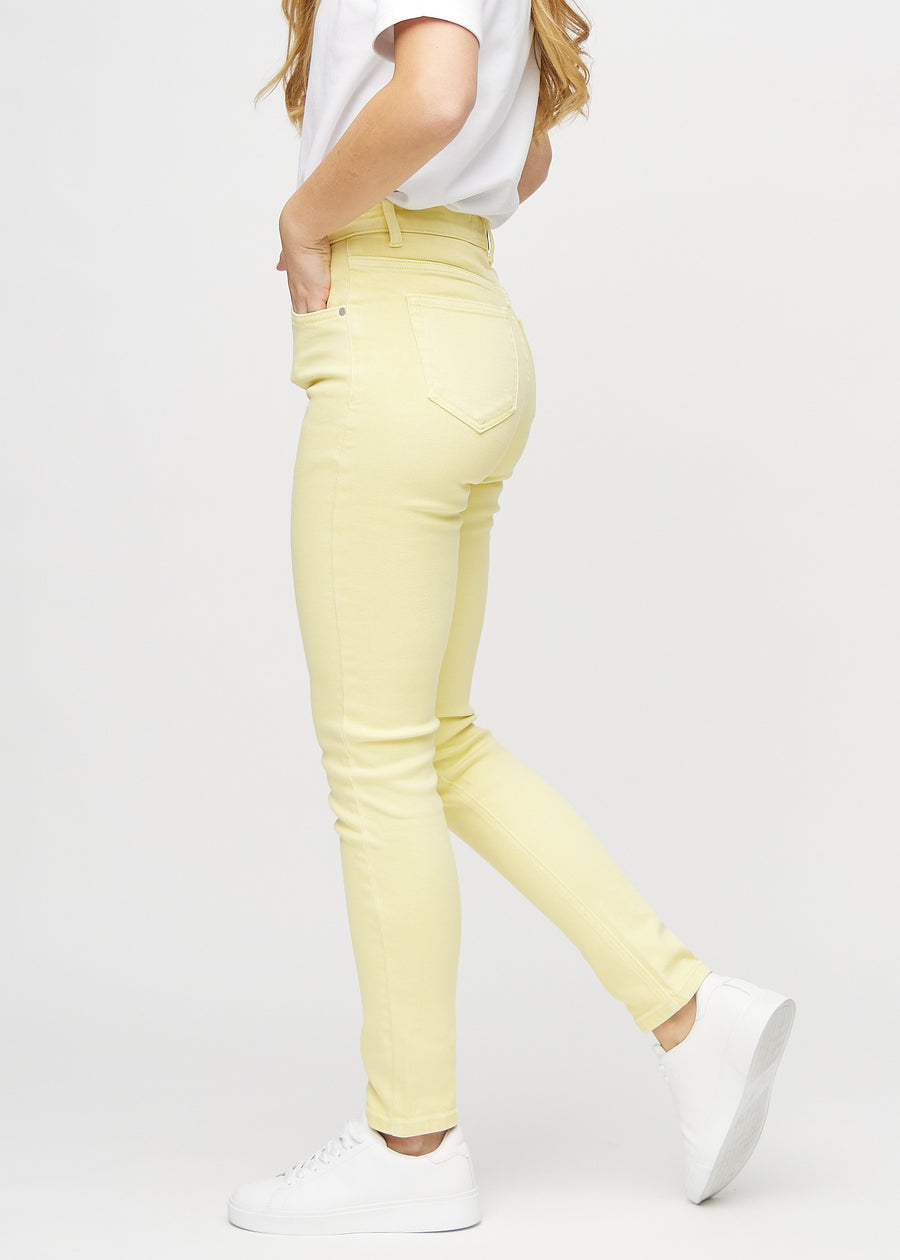 Slim jeans for women in light yellow, color Lemonades. Side view on a model.