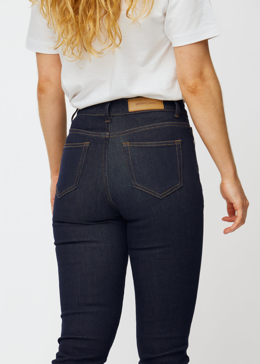 Deep dark blue denim jeans for women in the color Midnights seen from the back in close-up to show fit and details.