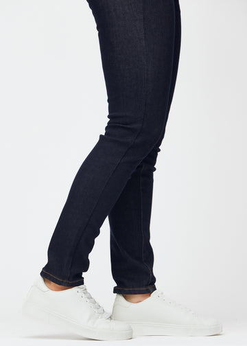 Deep dark blue denim jeans for women in the color Midnights with a slim fit shown in close-up at the ankles to show the tailored finish.