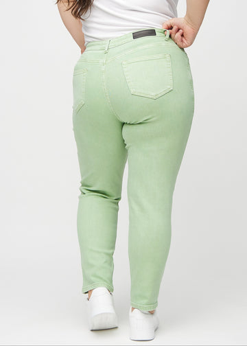 Light green slim jeans seen from the back on a plus-size model, so the entire product can be seen.