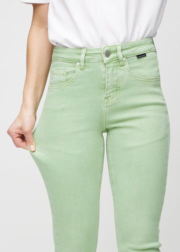 The model stretches the jeans at the thigh to show the stretch.