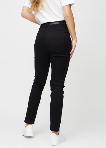Slim jeans for women in black, color Ravens. Back view on a model, showing the overall fit.