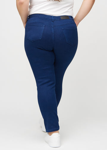 Dark blue slim jeans seen from the back on a plus-size model, so the entire product can be seen.