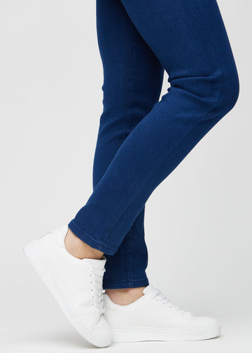 The ankles of a model, so you can see how tightly the jeans fit.