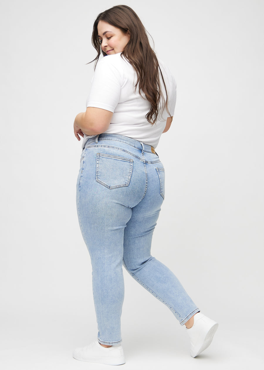 Slim jeans for women in light blue, color Waves. Side view on a plus-size model.