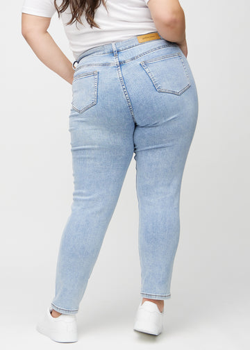 Slim jeans for women in light blue, color Waves. Back view on a plus-size model, showing the overall fit.