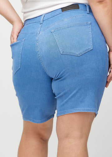 Blue regular middle shorts seen from the back up close on a plus-size model to show details.