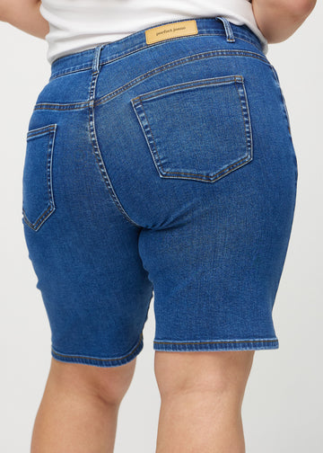 Dark denim regular middle shorts seen from the back close up on a plus-size model to show details.