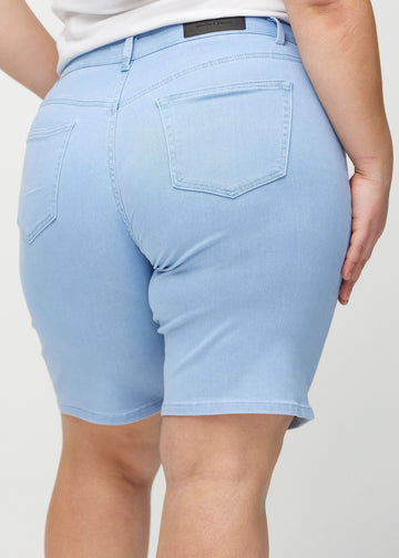 Light blue regular middle shorts seen from the back close up on a plus-size model to show details.