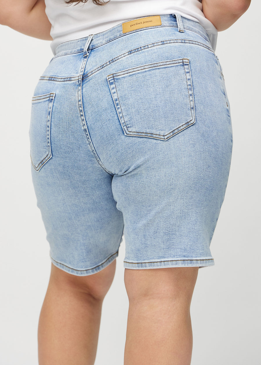 Light denim regular middle shorts seen from the back close up on a plus-size model to show details.