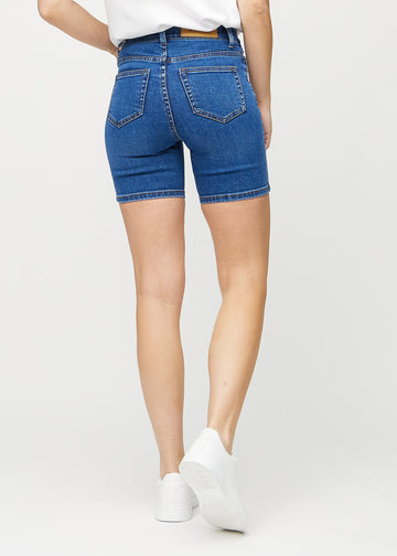 Dark denim skinny short shorts seen from the back, so the entire product can be seen.