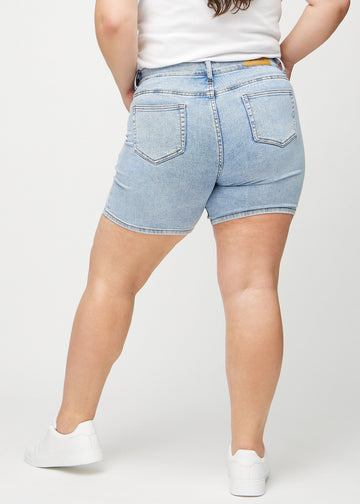 Light denim skinny short shorts seen from the back on a plus-size model, so the entire product can be seen.
