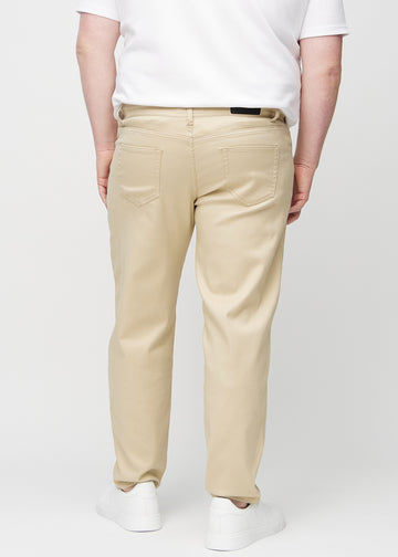 Beige regular jeans seen from the back on a plus-size model, so the entire product can be seen.