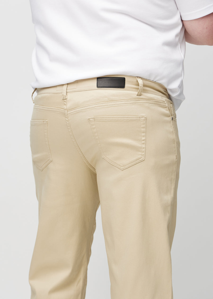 Beige regular jeans seen from the back up close on a plus-size model to show details.