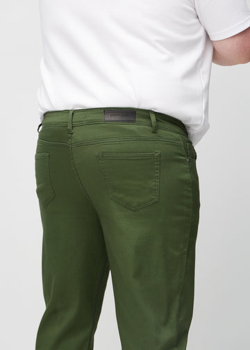 Dark green regular jeans seen from the back close up on a plus-size model to show details.