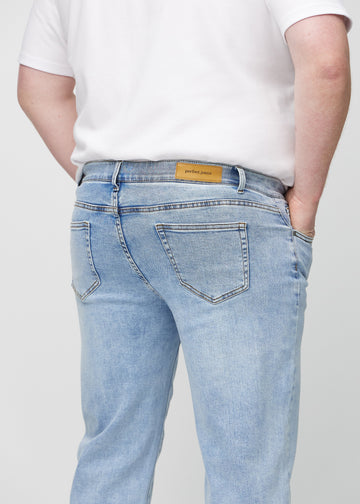 Light denim regular jeans seen from the back up close on a plus-size model to show details.