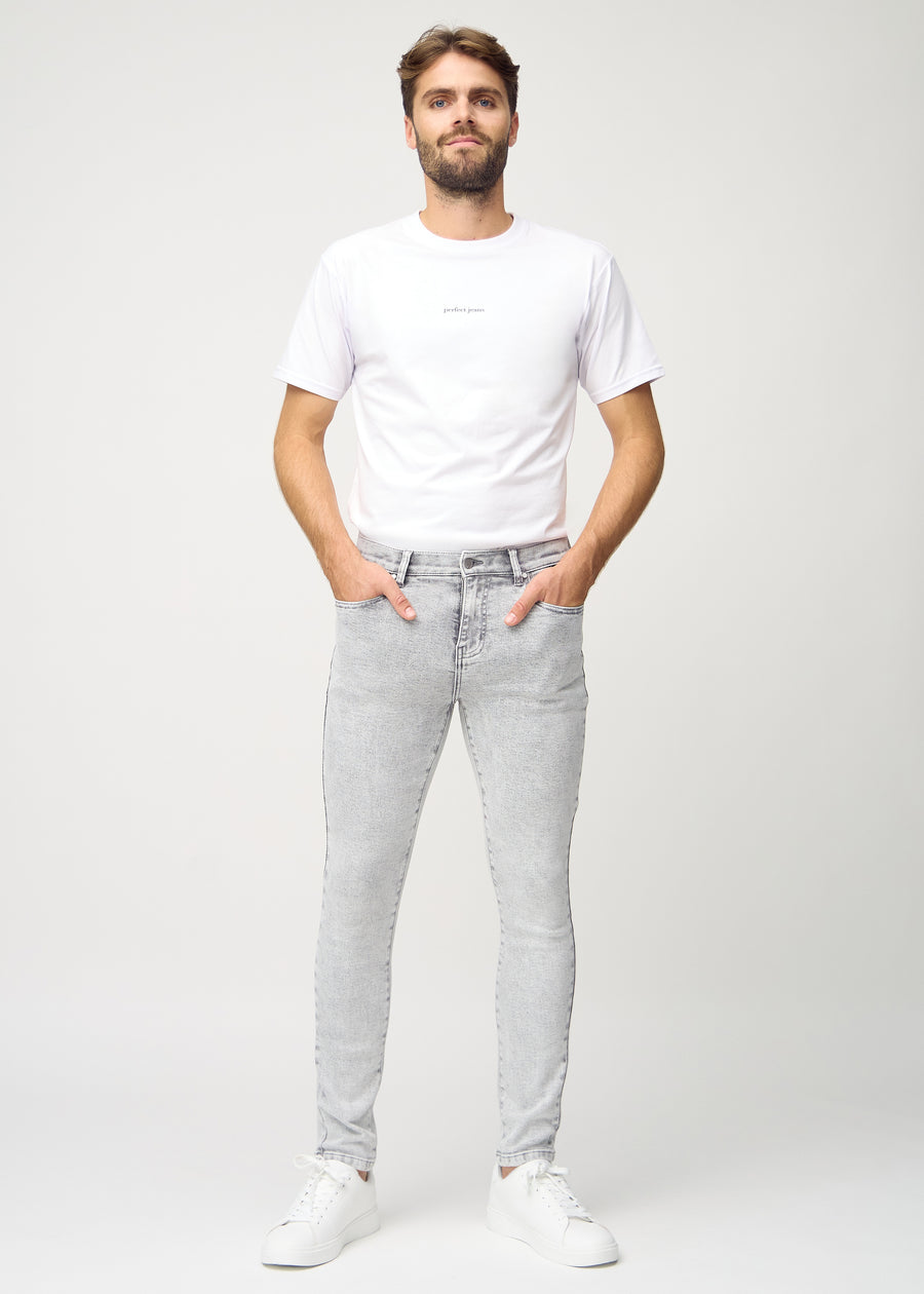 Full-length view of a model in light grey denim slim jeans.