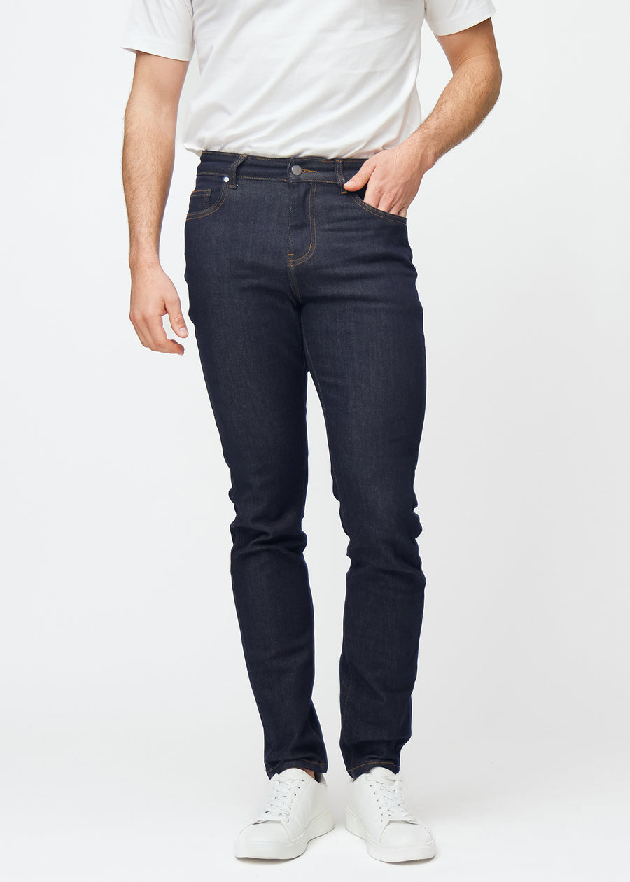 Deep dark blue denim jeans for men in the color Midnights with a slim fit that sits naturally at the hip and follows the legs more closely, front view.