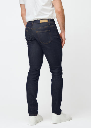 Deep dark blue denim jeans for men in the color Midnights seen from the back so the fit can be seen.