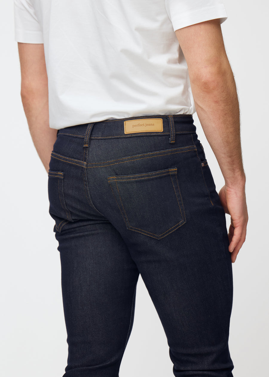 Deep dark blue denim jeans for men in the color Midnights seen from the back close up to show fit and details.