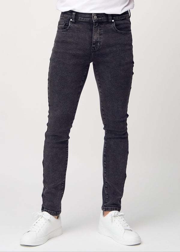Dark grey denim slim jeans, model name Shadows, fitted closely along the legs , front view.