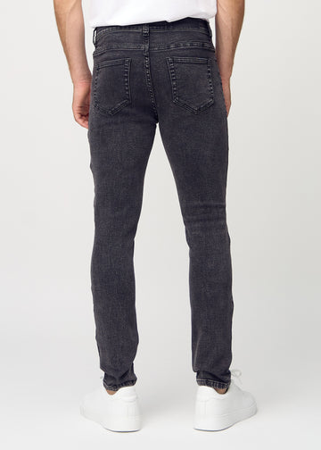 Dark grey denim slim jeans viewed from the back to show the full product.